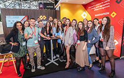 SOFTSWISS team posing together at an industry event near a branded booth.