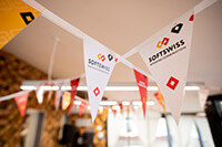 SOFTSWISS-branded bunting flags hanging in a decorated indoor space.