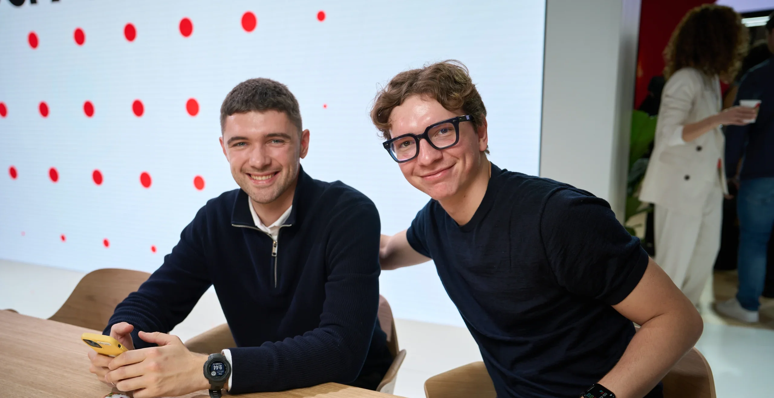 white background, two men sitting at the table