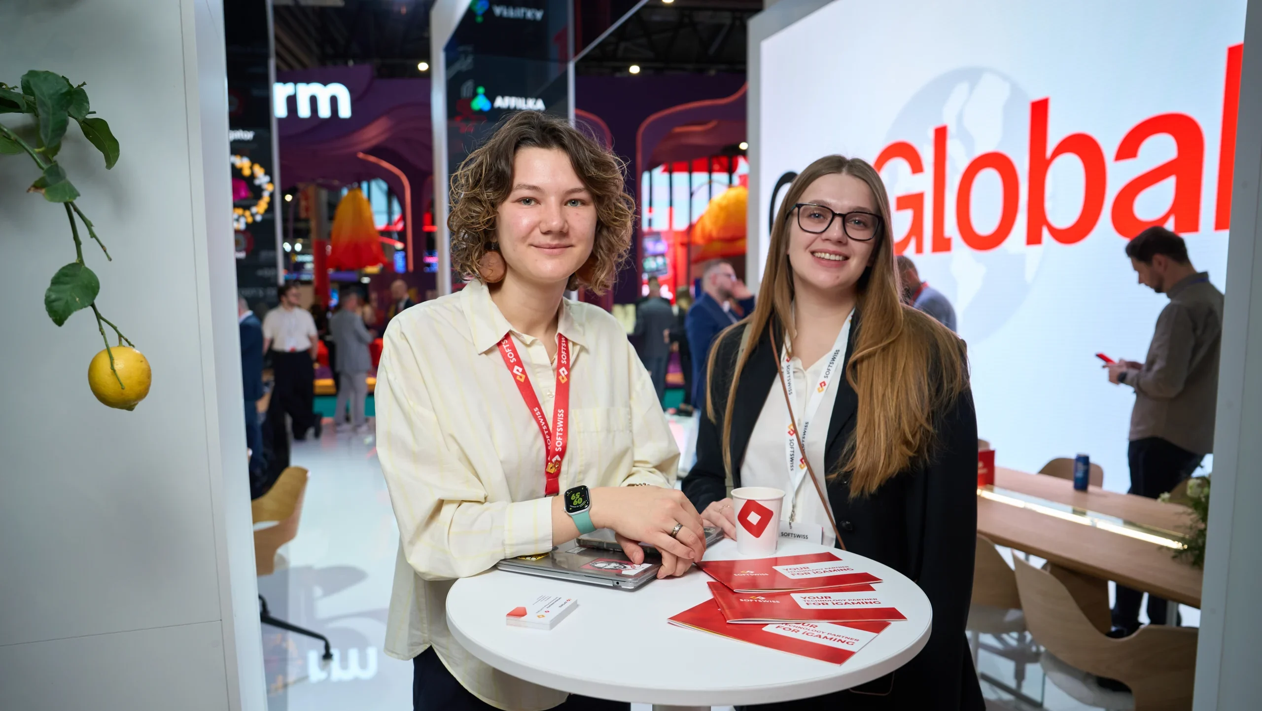 white and transparent booth, two women standing at the white table